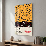 Glass wall art featuring Yayoi Kusama's Infinite Eyes design with bold pop art style, by Artdesigna.