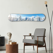 Snowy alpine landscape glass wall art by Artdesigna, featuring a mountain scene with snow-covered peaks and clear blue sky.